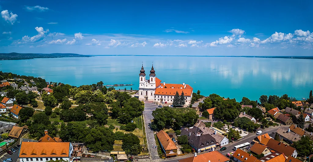Tihany, Hungary - Aerial panoramic view of the famous Benedictine Monastery of Tihany (Tihany Abbey) with beautiful coloruful Lake Balaton at background