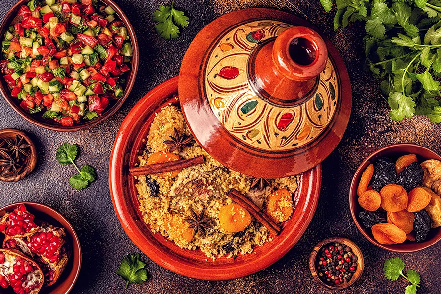 Traditional moroccan tajine of chicken with dried fruits and spices, top view.