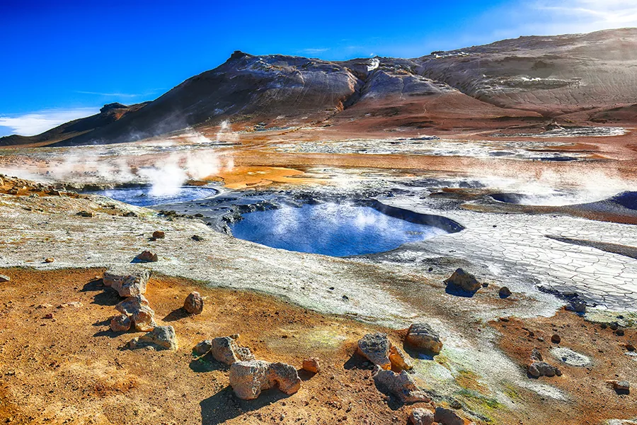 Boiling mudpots in the geothermal area Hverir and cracked ground around. Location: geothermal area Hverir, Myvatn region, North part of Iceland, Europe