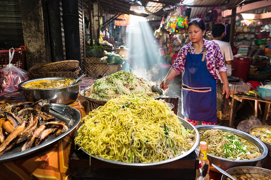Phnom Penh, Phnom Penh / Cambodia - September 27th 2016: Image of a Khmer rural women in the countryside selling street food in a open market in Cambodia.