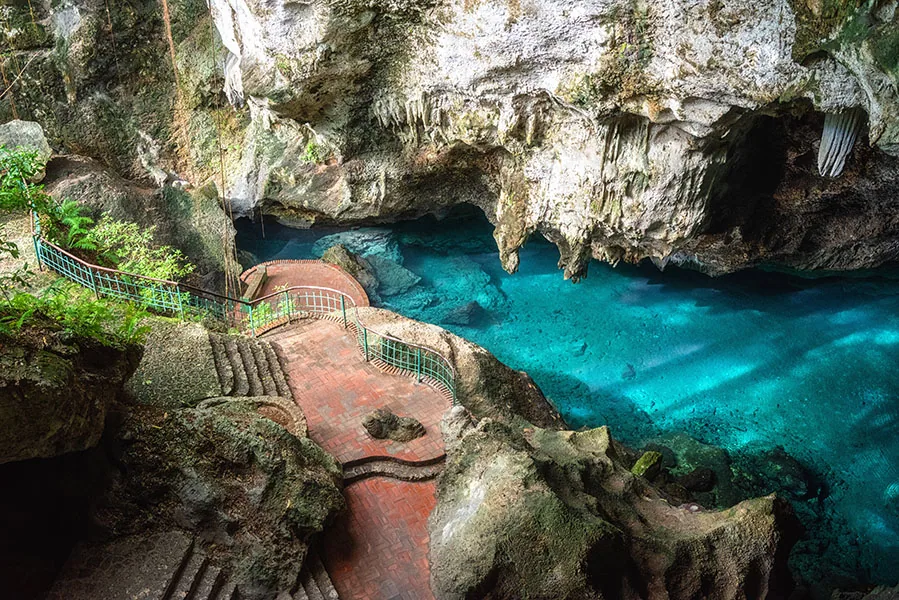 Three eyes cave in Santo Domingo, los Tres Ojos national park, Dominican Republic. Scenic view of limestone cave and crystal clear azure water of underground la
