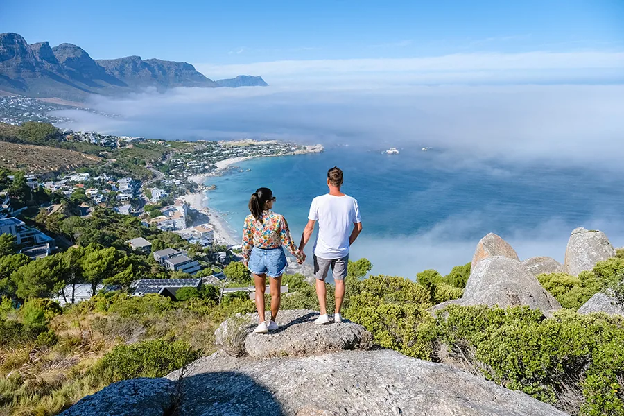 View from The Rock viewpoint in Cape Town over Campsbay, view over Camps Bay with fog over the ocean. fog coming in from ocean at Camps Bay Cape Town