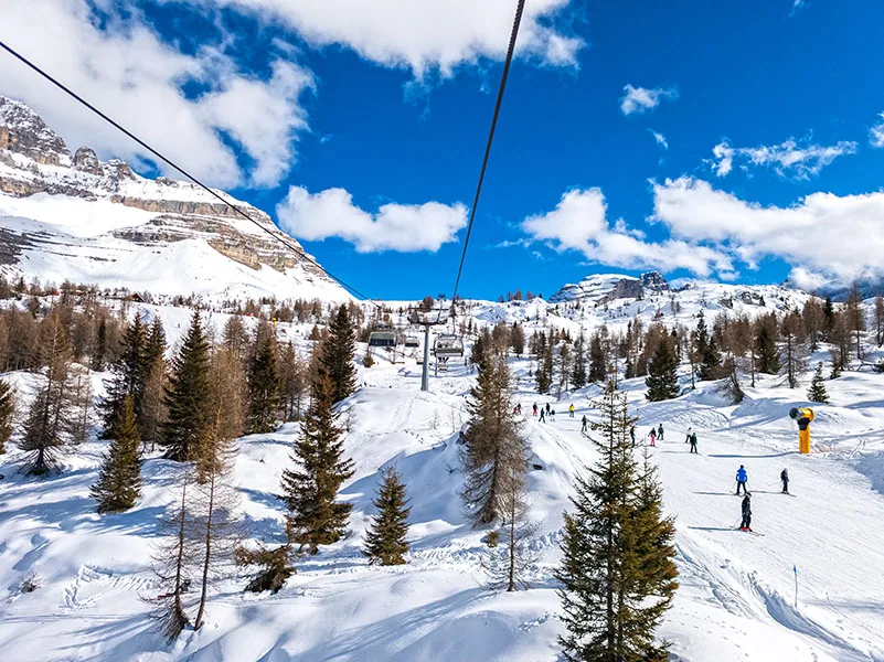 Madonna di Campiglio ski resort in Trentino, Dolomiti di Brenta, Italy - Skier on ski slope in ski resort in Italian Dolomites Alps
