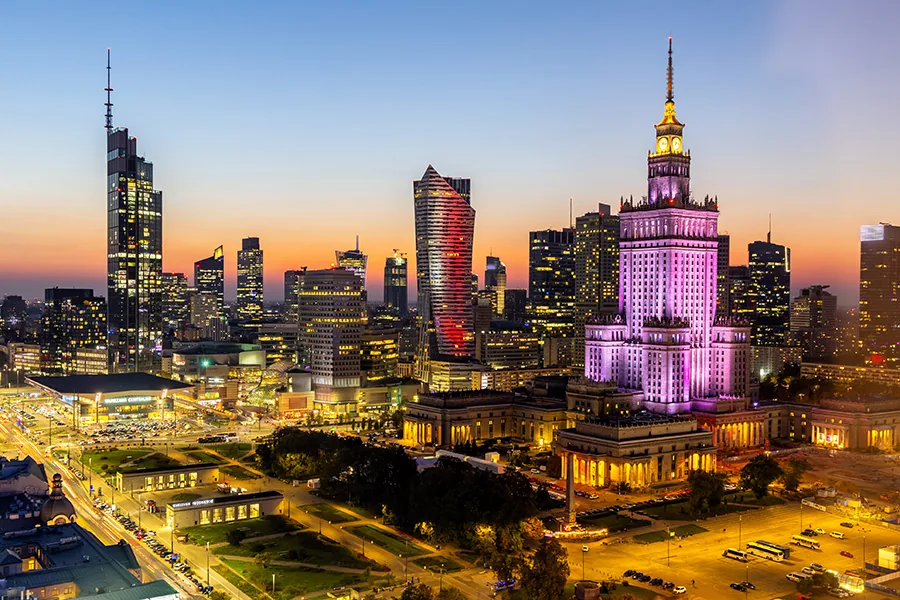 Warsaw skyline skyscraper with Palace of Culture and Science by night twilight in downtown in Warsaw, Poland