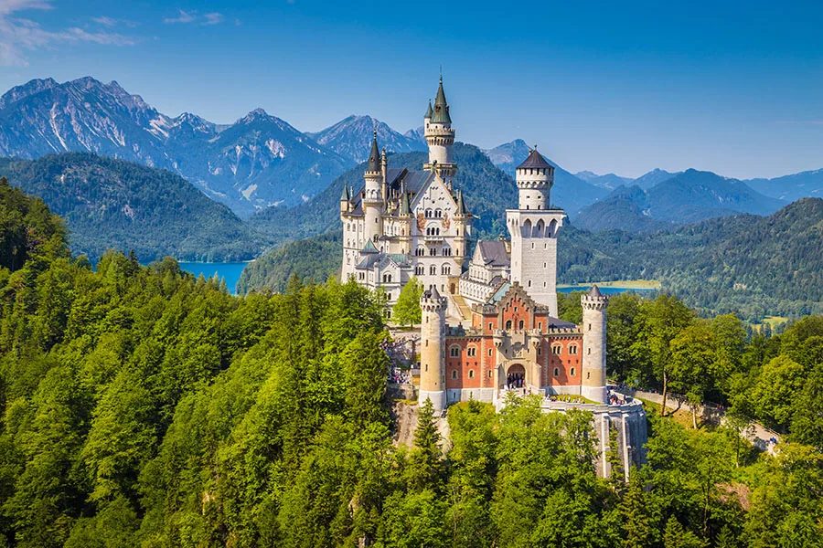 Fussen, Germany - August 7, 2015: Beautiful view of world-famous Neuschwanstein Castle, the nineteenth-century Romanesque Revival palace built for King Ludwig I