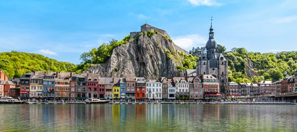 Colorful image with buildings and citadel along the Meuse river in Dinant, Wallonia, Belgium.