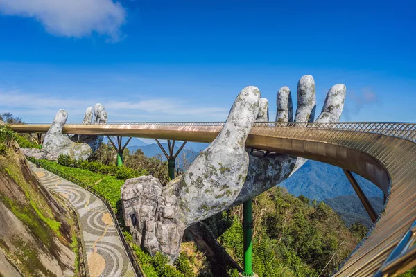 Da Nang, Vietnam, 28 december 2020:Top aerial view of the famous Golden Bridge is lifted by two giant hands in the tourist resort on Ba Na Hill in Da Nang, Viet