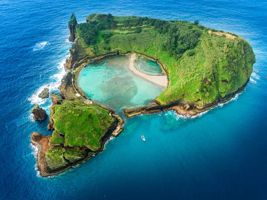 Aerial view of Ilheu de Vila Franca, a volcanic Azores island with a natural pool, ideal for swimming, snorkeling, and eco-tourism in a pristine coastal setting